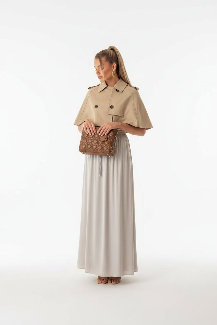 Women's beige cropped coat, double-breasted poncho coat, elegant women's outerwear, chic beige jacket women, luxury women's coat, cropped trench style coat, sophisticated outerwear women, fall fashion coat women, spring layering jacket women, smart casual women's coat, tailored poncho jacket, women's business casual outerwear, fashionable beige coat, designer-inspired women's jacket, modern elegant outerwear, timeless women's coat, luxury neutral coat women, women's transitional jacket.