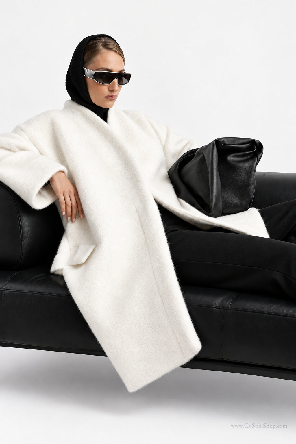 Women's black V-neck coat
Women's white V-neck coat
Women's coat with covered-button closure
Close-up of women's V-neck coat
Women's black coat front view
Women's white coat front view
Women's coat styled with trousers
Women's coat styled with jeans
Women's coat with full-length sleeves