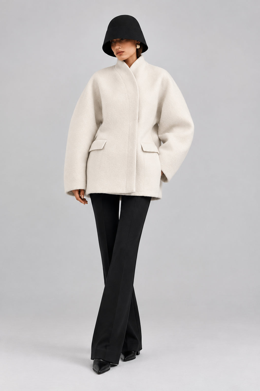 Women's black V-neck coat
Women's white V-neck coat
Women's coat with covered-button closure
Close-up of women's V-neck coat
Women's black coat front view
Women's white coat front view
Women's coat styled with trousers
Women's coat styled with jeans
Women's coat with full-length sleeves