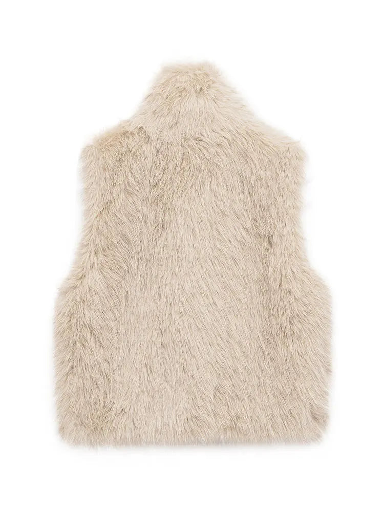 Women's short faux fur vest styled over a long-sleeve top