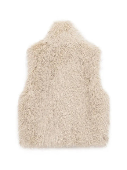 Women's short faux fur vest styled over a long-sleeve top
