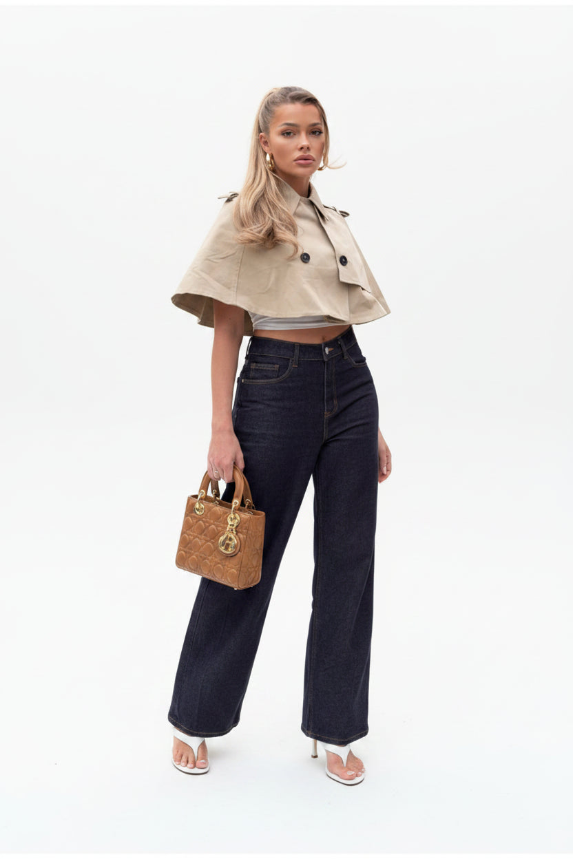 Women's beige cropped coat, double-breasted poncho coat, elegant women's outerwear, chic beige jacket women, luxury women's coat, cropped trench style coat, sophisticated outerwear women, fall fashion coat women, spring layering jacket women, smart casual women's coat, tailored poncho jacket, women's business casual outerwear, fashionable beige coat, designer-inspired women's jacket, modern elegant outerwear, timeless women's coat, luxury neutral coat women, women's transitional jacket.