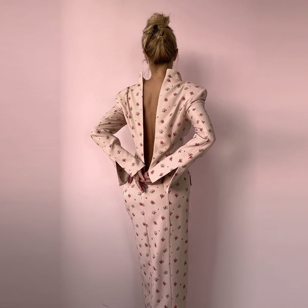 Floral midi dress features structured shoulders and a central button up closure reminiscent of former Blazer style.