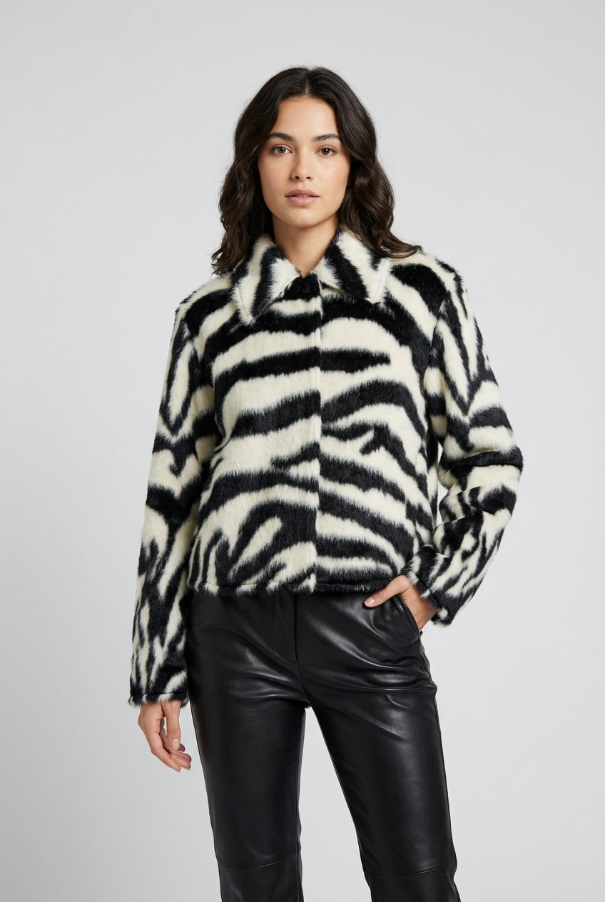 Women's zebra-print jacket paired with a simple outfit for a statement look