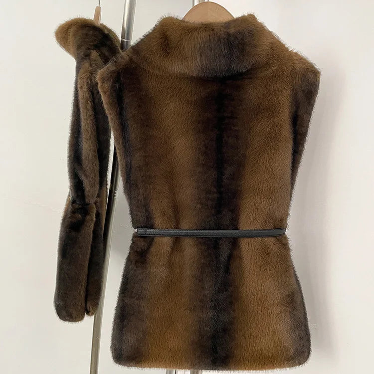 Women's faux fur vest in beige, front view

Women's plush faux fur vest with matching belt

Women's brown faux fur vest, sleeveless design

Women's faux fur vest with long front and short back

Close-up of plush faux fur vest texture

Women's faux fur vest styled with a long-sleeve top