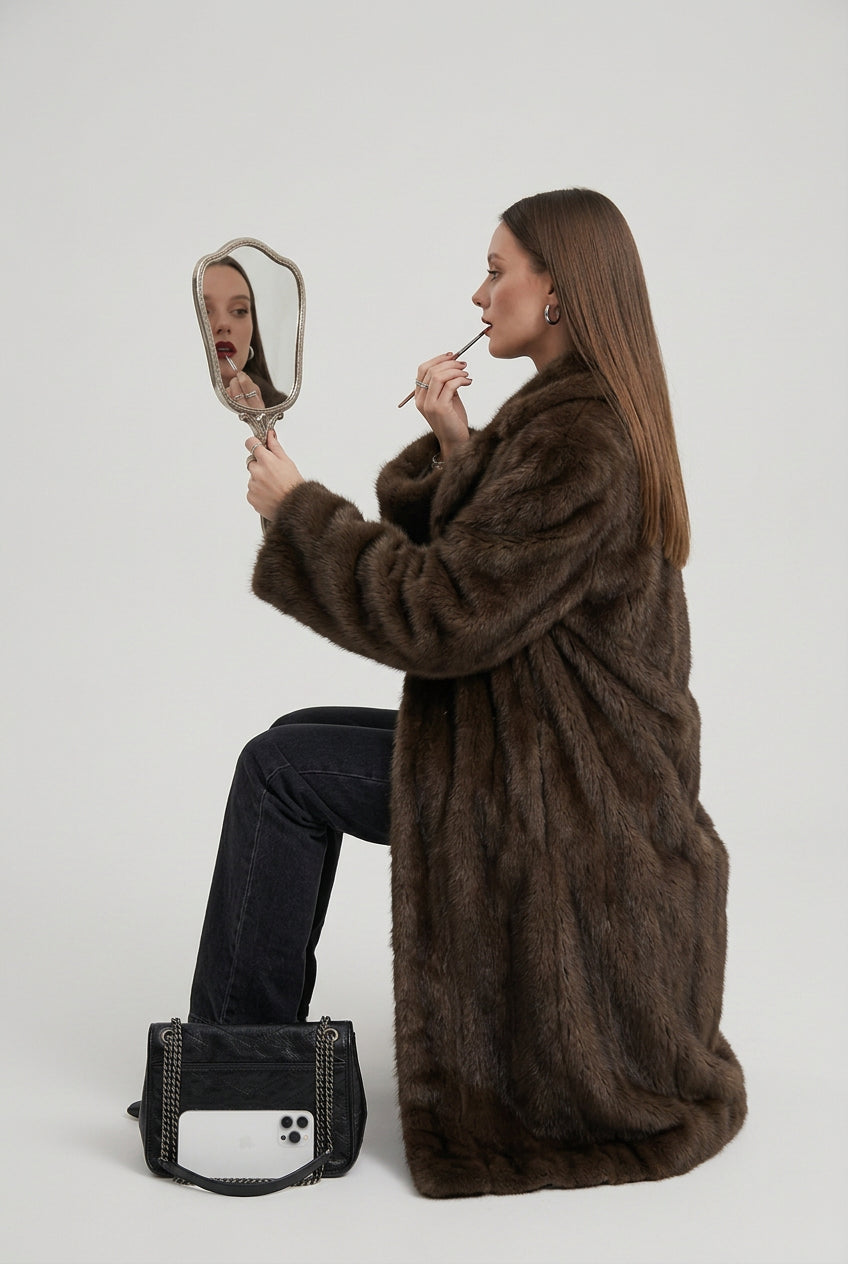 Gradient faux fur coat showing its long silhouette