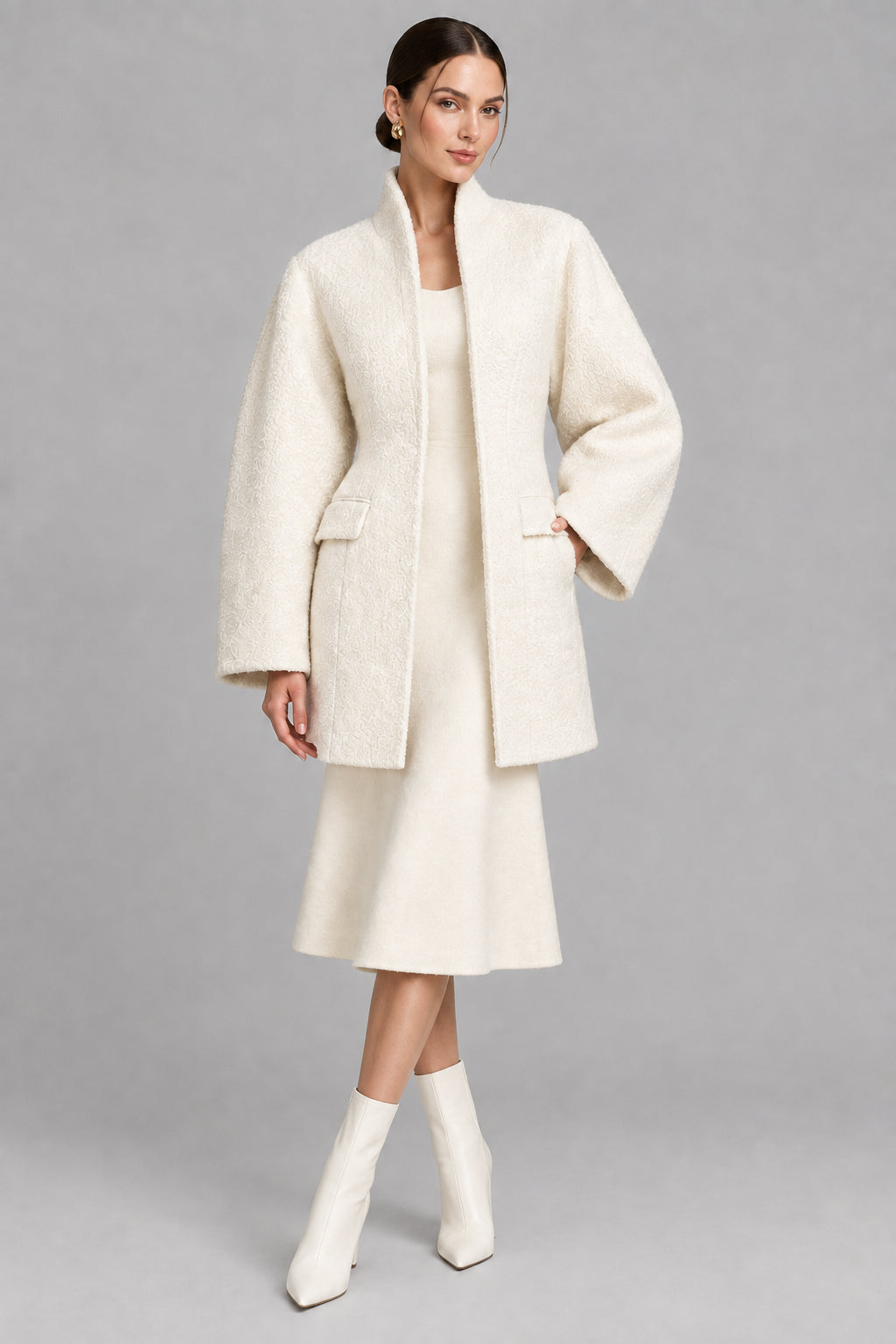 Women's black V-neck coat
Women's white V-neck coat
Women's coat with covered-button closure
Close-up of women's V-neck coat
Women's black coat front view
Women's white coat front view
Women's coat styled with trousers
Women's coat styled with jeans
Women's coat with full-length sleeves