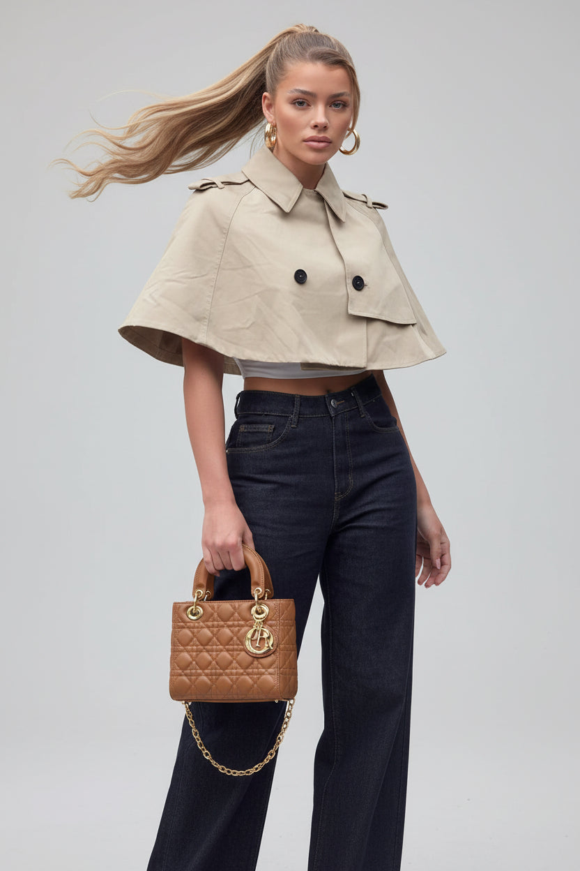 Women's beige cropped coat, double-breasted poncho coat, elegant women's outerwear, chic beige jacket women, luxury women's coat, cropped trench style coat, sophisticated outerwear women, fall fashion coat women, spring layering jacket women, smart casual women's coat, tailored poncho jacket, women's business casual outerwear, fashionable beige coat, designer-inspired women's jacket, modern elegant outerwear, timeless women's coat, luxury neutral coat women, women's transitional jacket.