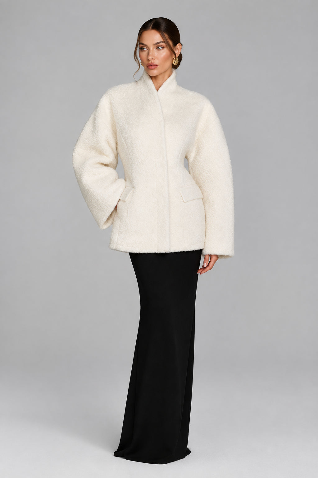 Women's black V-neck coat
Women's white V-neck coat
Women's coat with covered-button closure
Close-up of women's V-neck coat
Women's black coat front view
Women's white coat front view
Women's coat styled with trousers
Women's coat styled with jeans
Women's coat with full-length sleeves