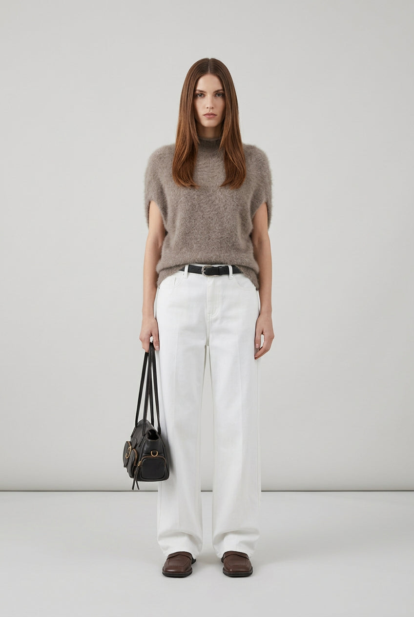 Women's turtleneck knit vest styled for an elegant autumn outfit