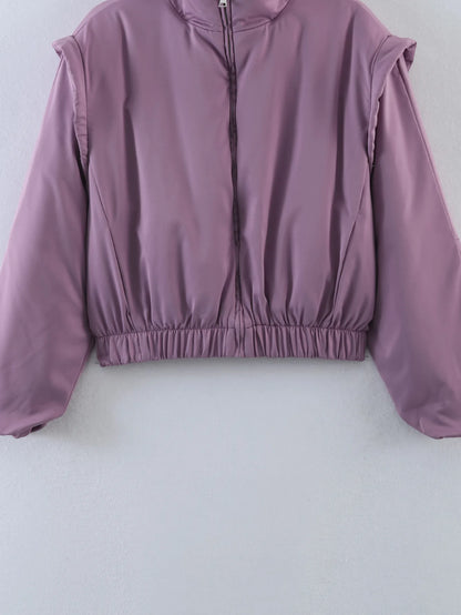 Detail of the glossy satin finish on the cropped bomber jacket