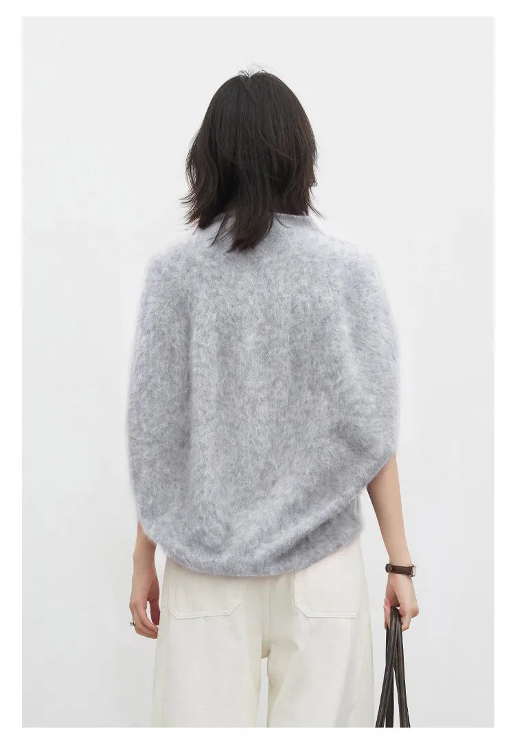 Sleeveless turtleneck knit vest styled as a layering piece