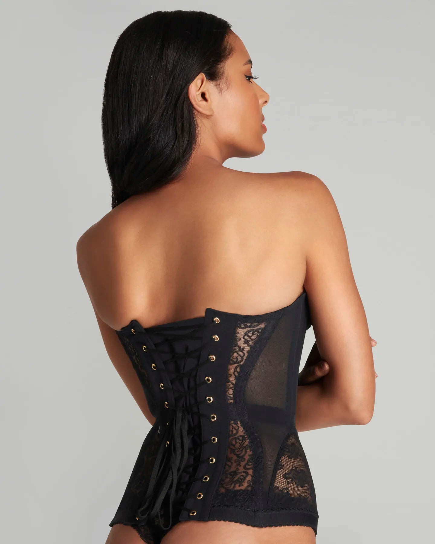 Woman wearing black strapless lace corset top
Structured floral lace corset front view
Strapless bustier side profile
Lace corset fabric detail close-up
Black corset styled with jeans
Elegant corset outfit inspiration
Back view structured corset
Lace corset night outfit