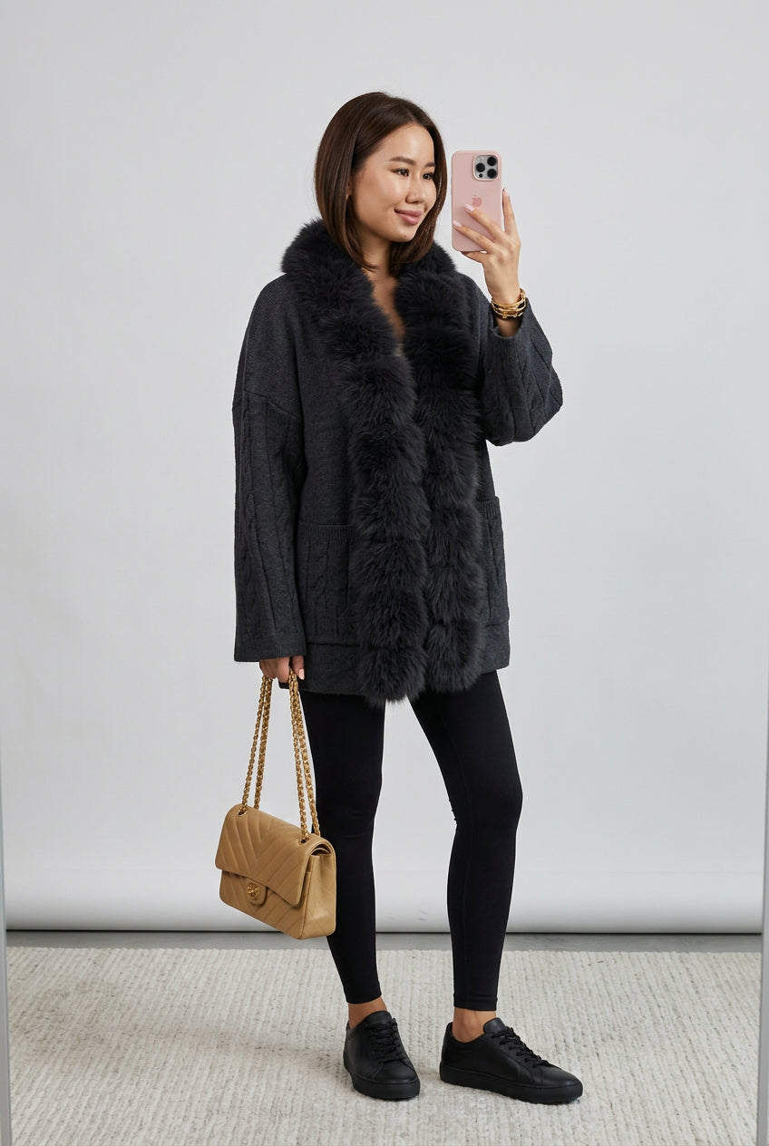 Close-up of the cardigan's cable-knit texture and faux-fur edging