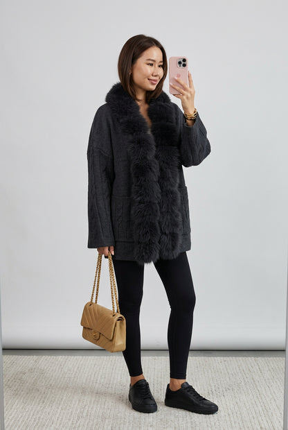 Close-up of the cardigan's cable-knit texture and faux-fur edging