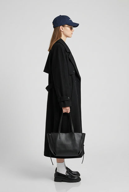 Black long coat styled for a refined everyday look