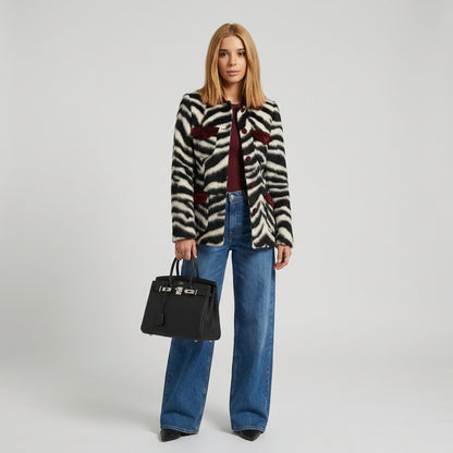 Zebra print faux fur coat showing its regular-length silhouette